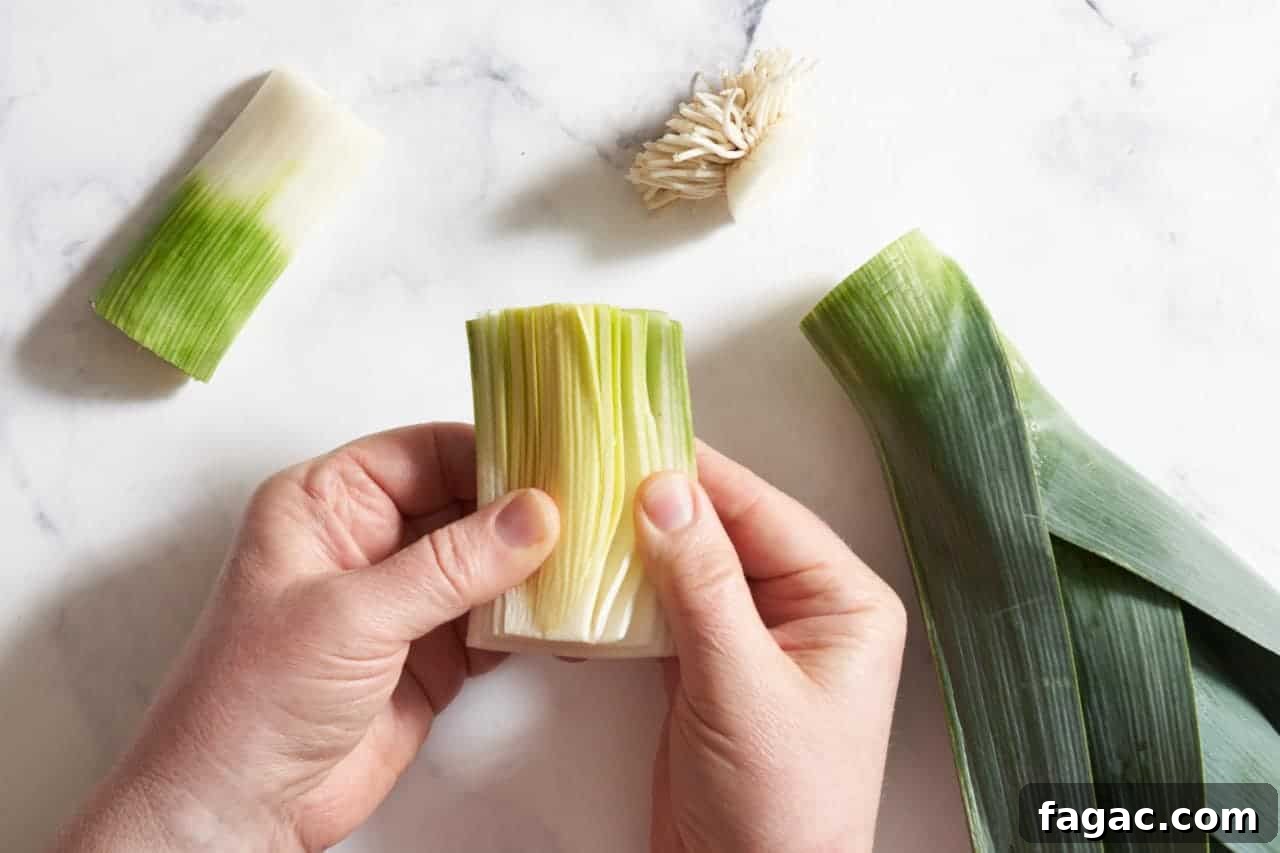 Braised Pork with White Beans, Wine & Fresh Sage 5 A woman's hands spreading open the layers of a leek to clean it.