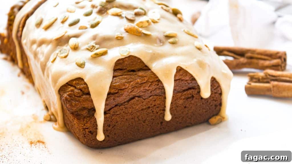 Maple Brown Butter Glazed Pumpkin Bread with Sour Cream 5 glaze dripping off of pumpkin bread loaf