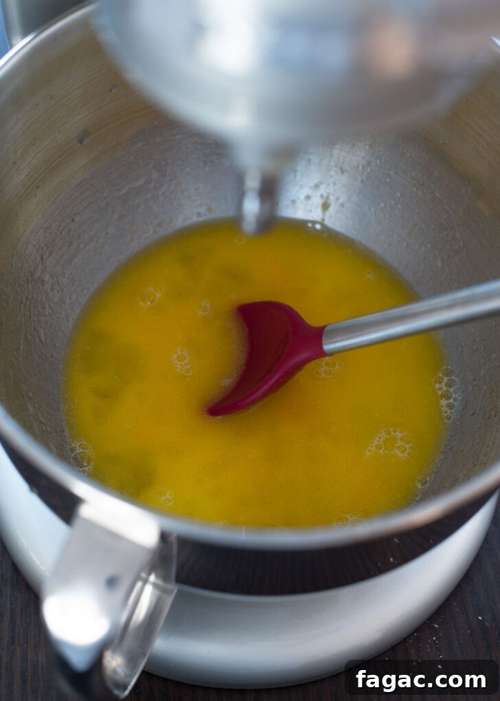Korean Kkwabaegi Twisted Donuts Recipe: Soft Cinnamon Treats 5 Wet ingredients for kkwabaegi mixed with a spoon in a bowl