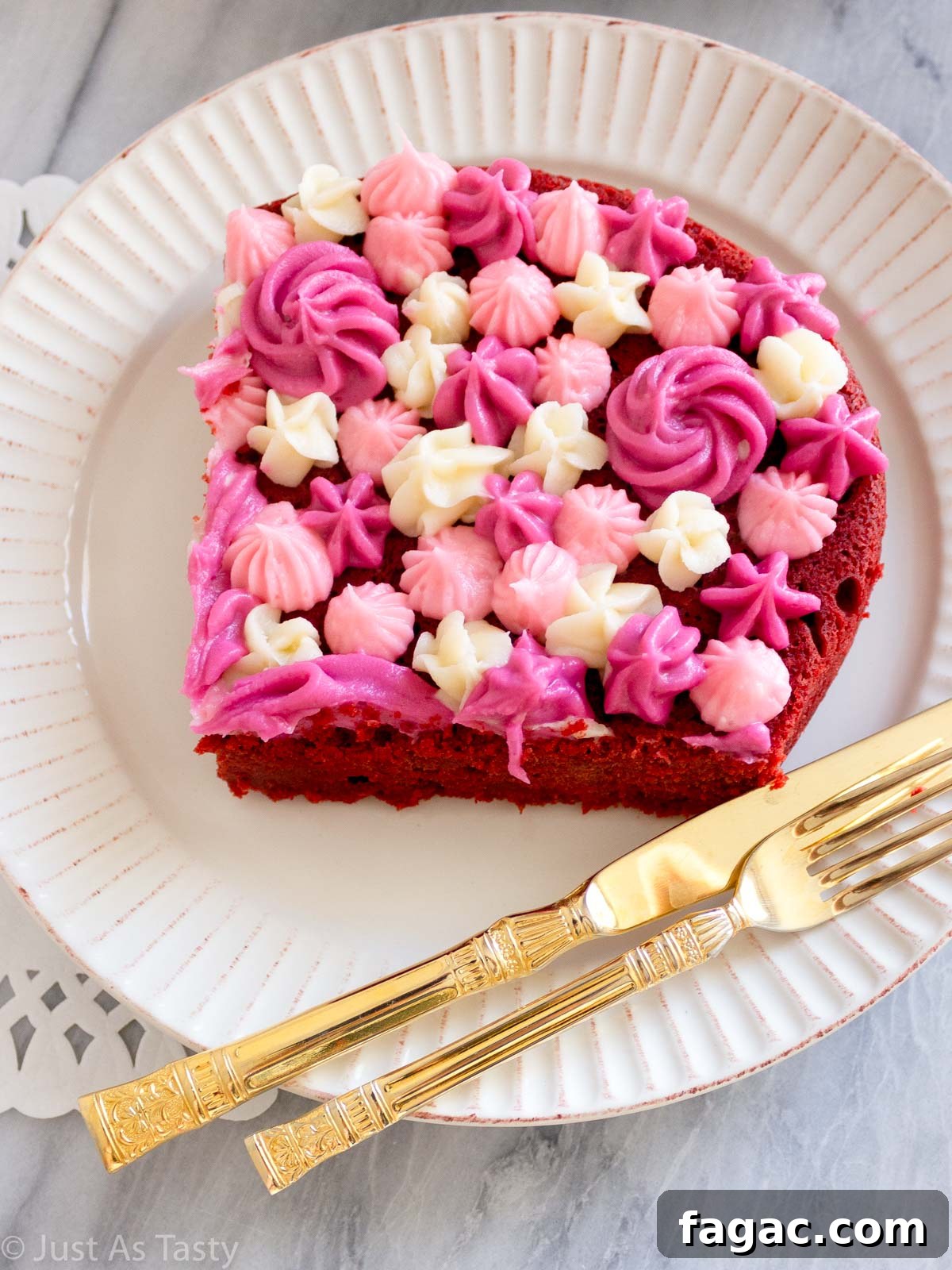 Gluten-Free Red Velvet Cake Recipe — Moist, Classic Flavor 3 Slice of gluten free red velvet cake with pink and white piped frosting on top.