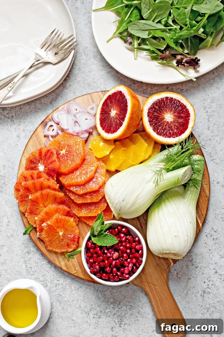 ingredients needed to make fennel and orange salad on a wooden cutting board