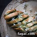 Crispy Wild Garlic Bread Recipe for Spring Gatherings 12 Freshly baked golden garlic bread scattered with tiny white wild garlic flowers