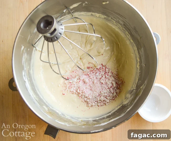 adding peppermint candies to Mini Cookie Peppermint Cheescake batter