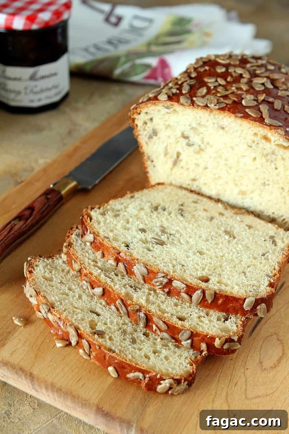 Crunchy Sunflower Seed Bread Recipe for Nutty Homemade Loaves 2 A delicious bread with both honey and sunflower seeds in the bread and scattered on top. Slices are cut open to show inside of bread loaf.