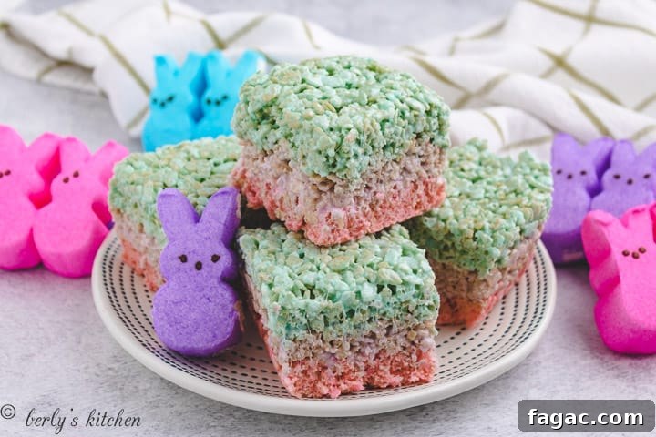 Layered Easter rice krispie treats on a white plate.