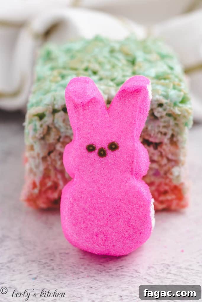 Pink peep in front of a rice krispie treat.