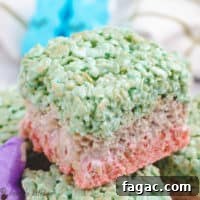 Layered Easter rice krispie treats stacked on a white plate.