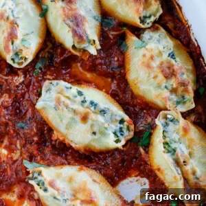 Spinach and Artichoke Stuffed Pasta Shells for Dinner 7 A baking dish with spinach artichoke stuffed shells in tomato basil marinara sauce.