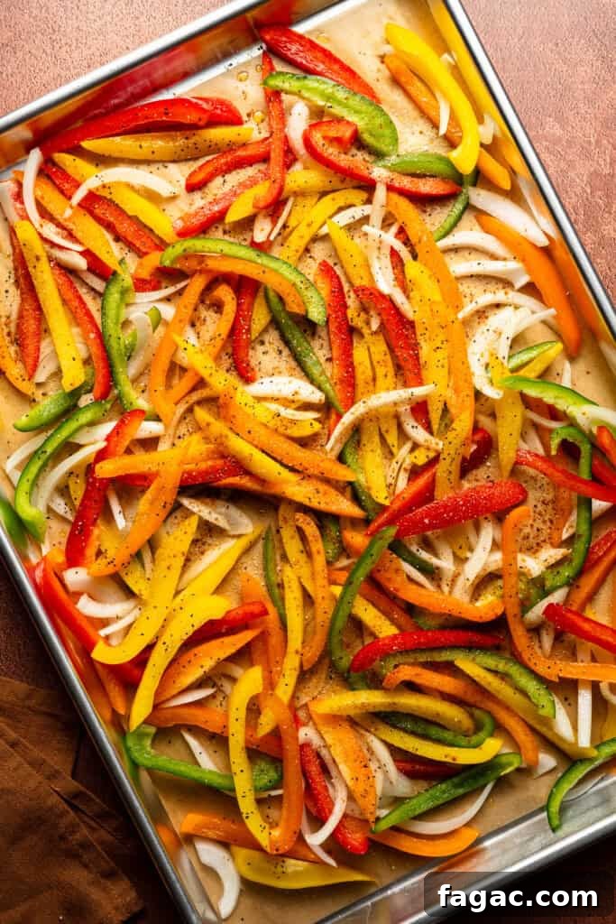 Weeknight Sheet Pan Chicken Fajitas Recipe for Quick Dinners 6 A pan of the seasoning and veggies tossed together, before being roasted.