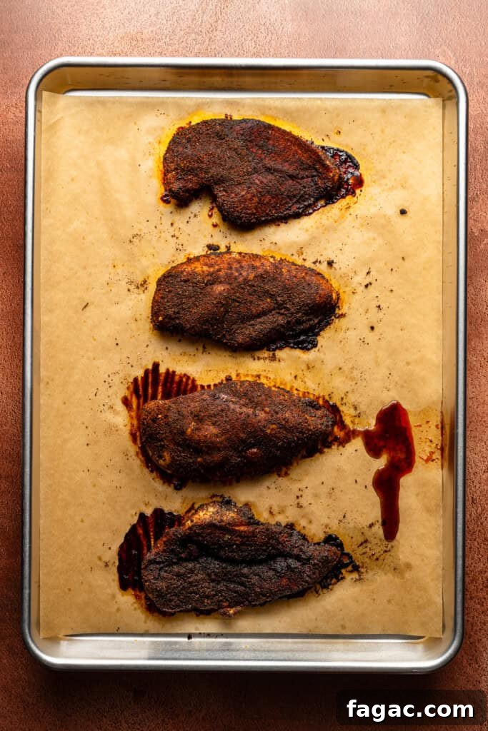 Weeknight Sheet Pan Chicken Fajitas Recipe for Quick Dinners 8 A sheet pan of the baked chicken breasts, coated heavily in fajita seasoning.