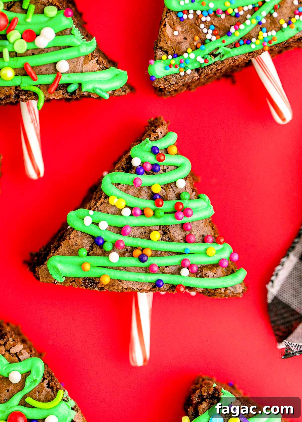 Close up photo of brownie christmas trees laying on a red surface.