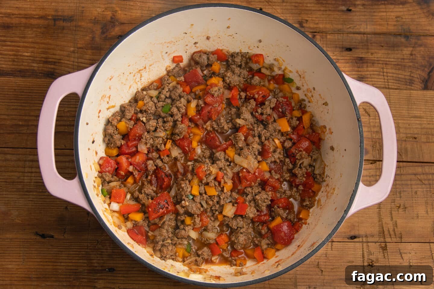 Creamy Beef Taco Soup Recipe with Cheesy Tortilla Toppings 6 This is a picture of the pot with tomatoes added to the veggies and the beef.