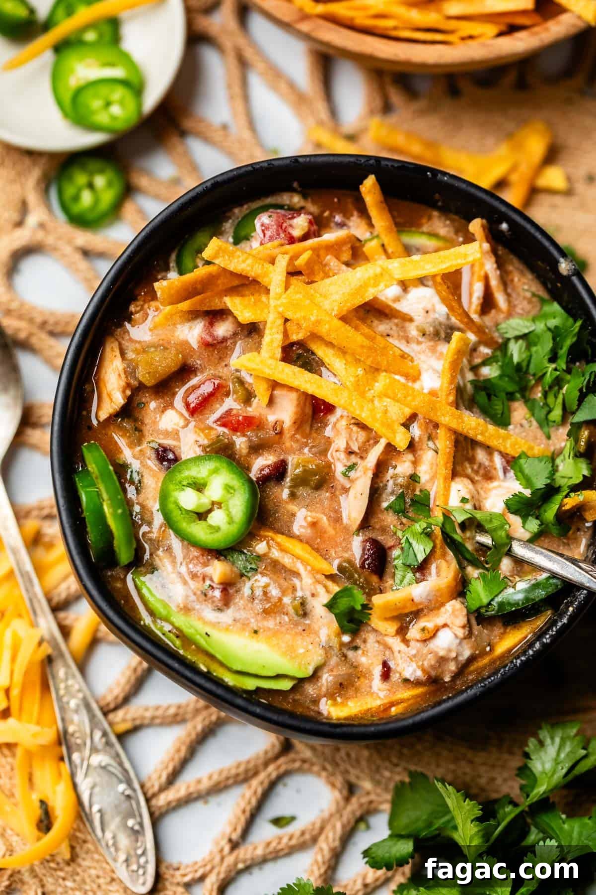 Quick Chicken Tortilla Soup Recipe for Cozy Weeknight Meals 4 a bowl of tortilla chicken soup looking more creamy because of sour cream mixed in.