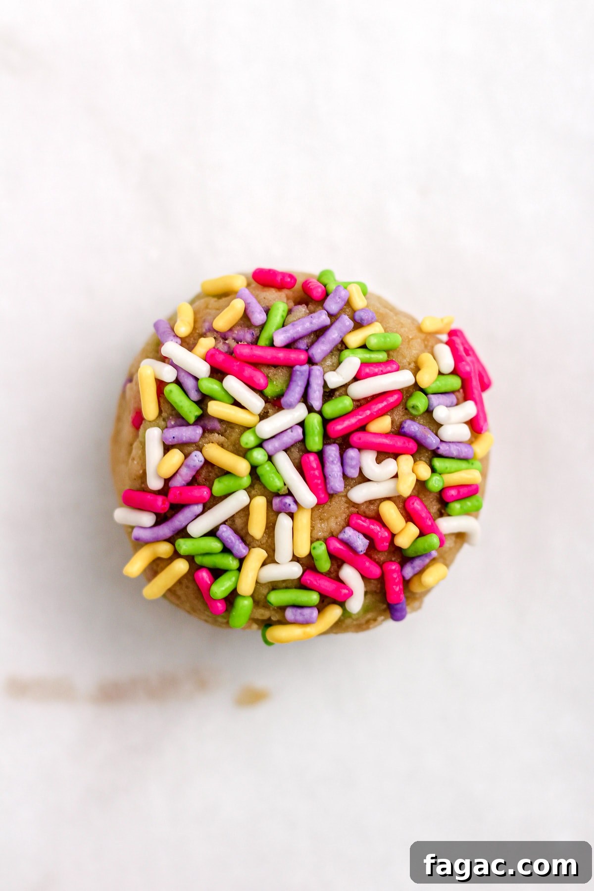 Sprinkle sugar cookie dough ball on a parchment paper lined baking sheet.