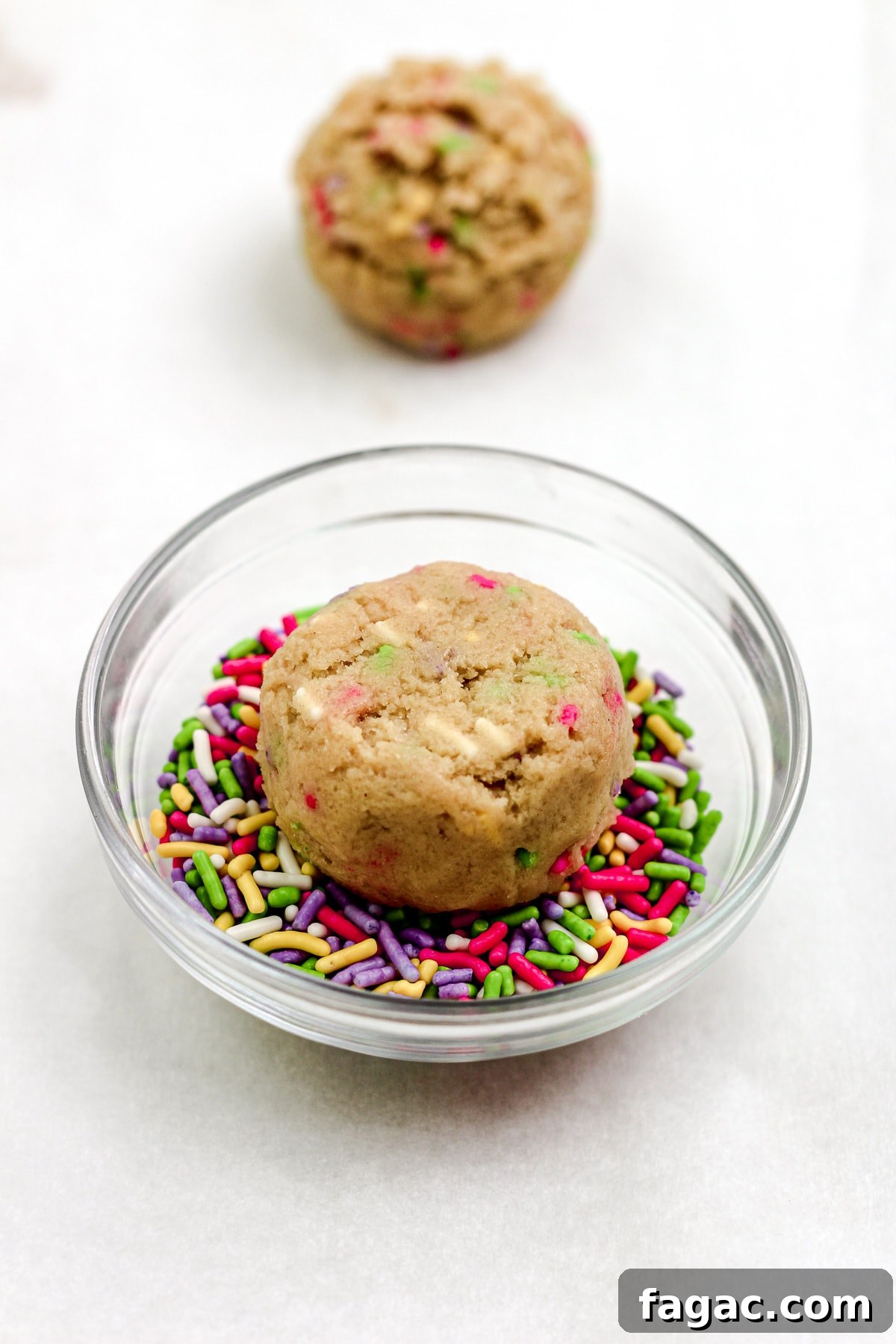 Sprinkle sugar cookie dough ball on a parchment paper lined baking sheet.