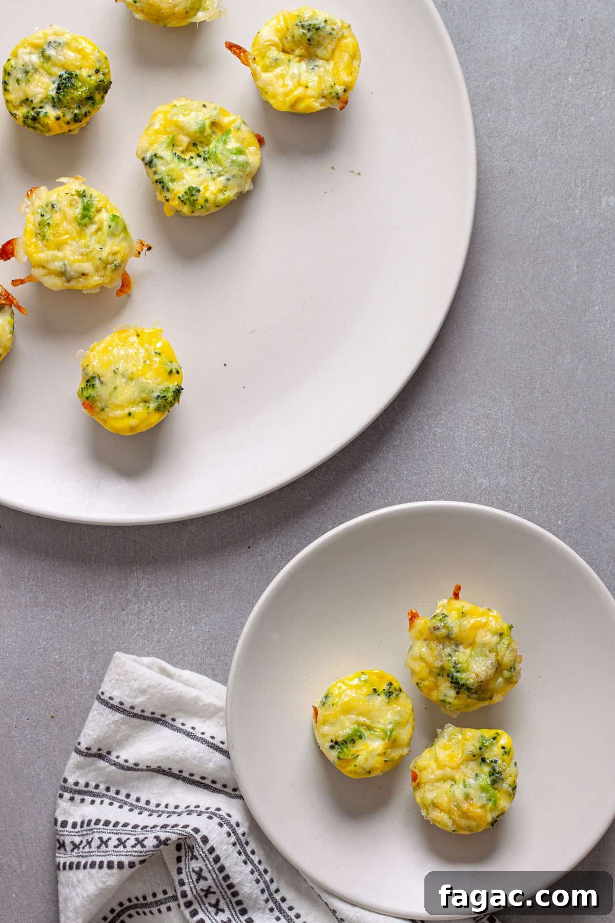 Broccoli Cheddar Mini Egg Bites: Protein-Packed Breakfast Bites 11 A serving of mini egg bites on a small plate with a platter of more egg bites in the background.