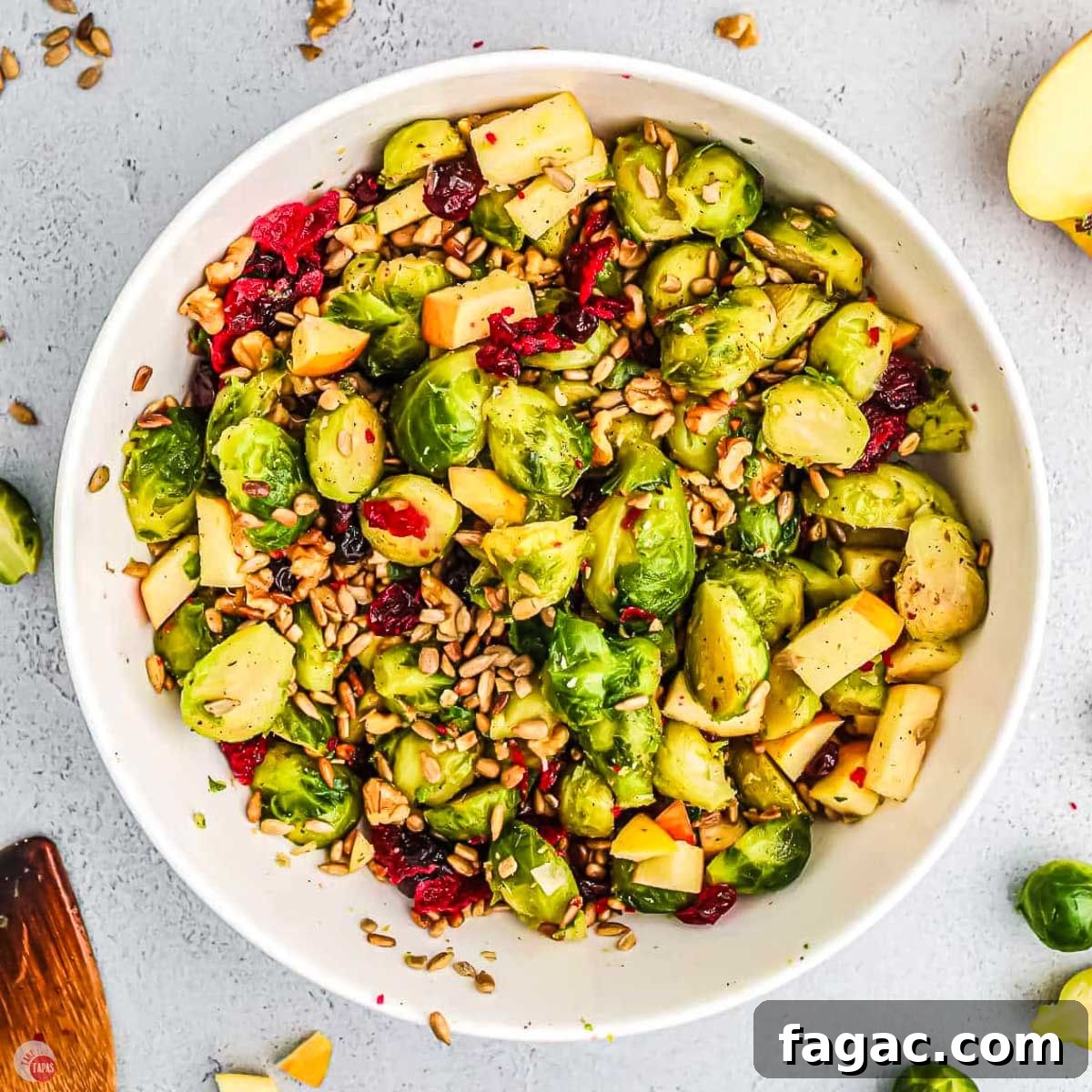 Shaved Brussels Sprouts and Cranberry Salad with Toasted Almonds 13 bowl of salad with sprouts and apples