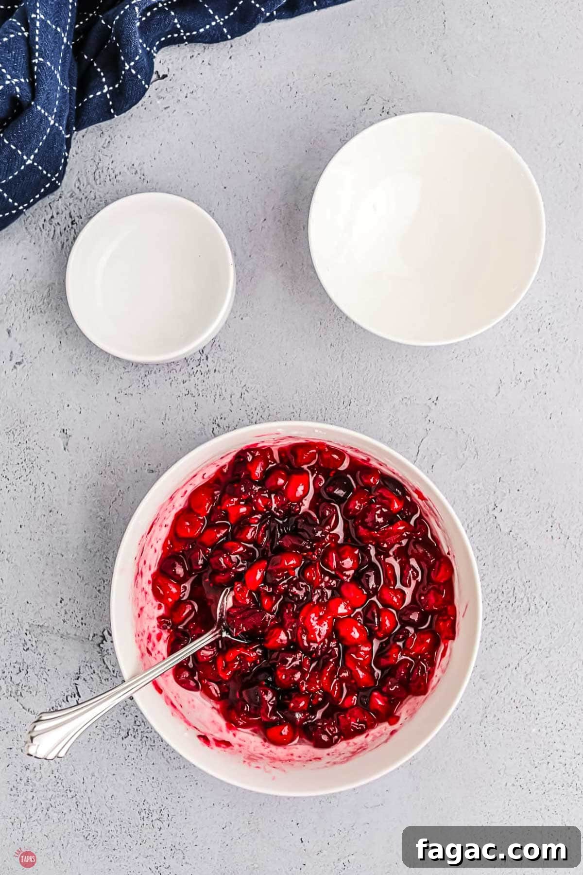 Shaved Brussels Sprouts and Cranberry Salad with Toasted Almonds 4 cranberries in a bowl with sugar and a small spoon