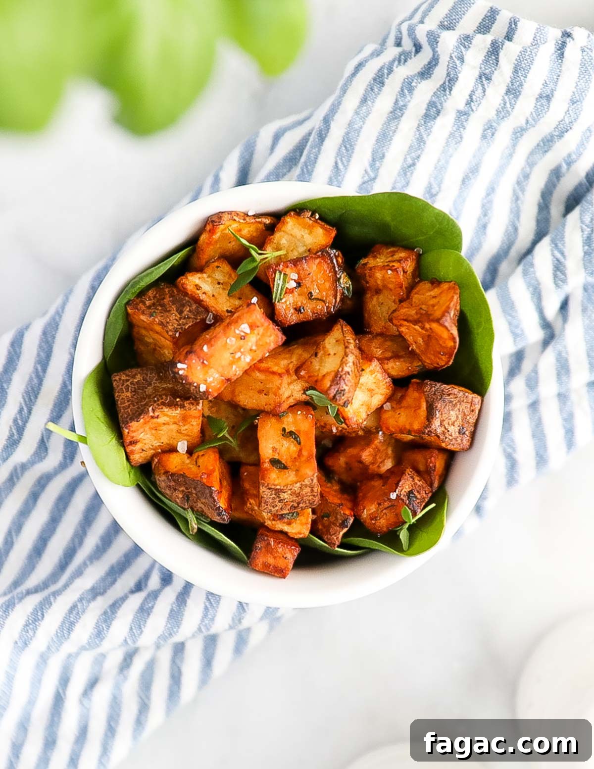 Crispy diced potatoes in a small white bowl