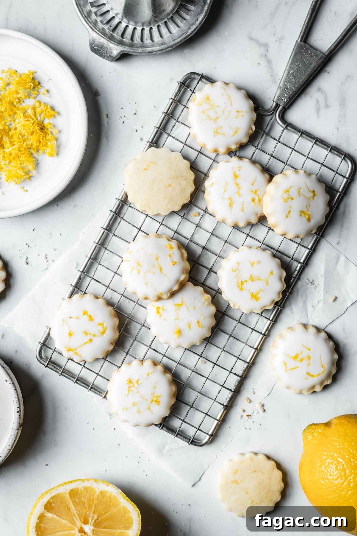 Lemon shortbread cookies with white glaze and lemon zest sprinkled on top