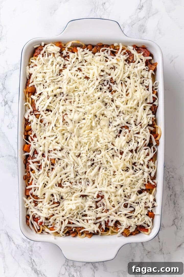 Assemble the casserole. Overhead view of million dollar spaghetti in dish before baking.