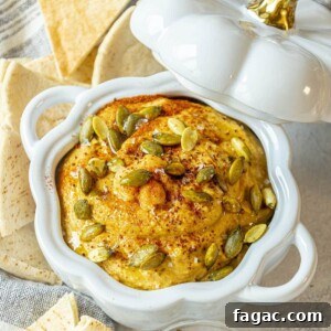 Creamy Pumpkin Hummus Recipe for Fall Appetizers 14 picture of pumpkin hummus in a glass pumpkin bowl