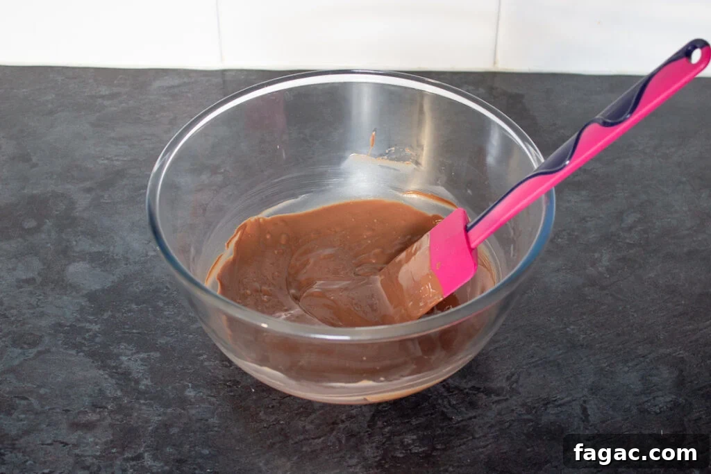 Quick Mars Bar Slice Recipe — No-Bake Chocolate Treat 8 Melted chocolate in a glass bowl.