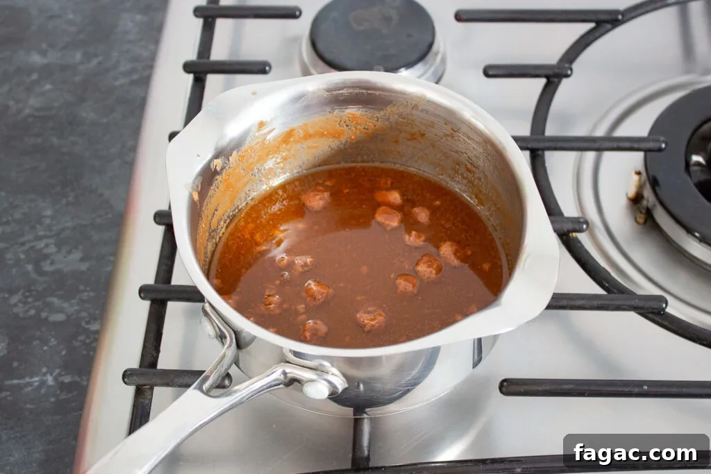 Quick Mars Bar Slice Recipe — No-Bake Chocolate Treat 5 Mars Bars, butter and golden syrup melting in a saucepan.