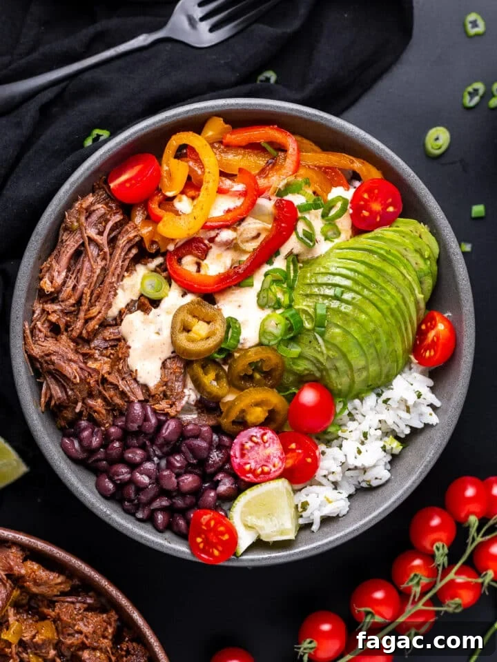 grey bowl with cilantro lime rice, shredded beef, sauteed veggies, black beans, pickled jalapenos and queso sauce