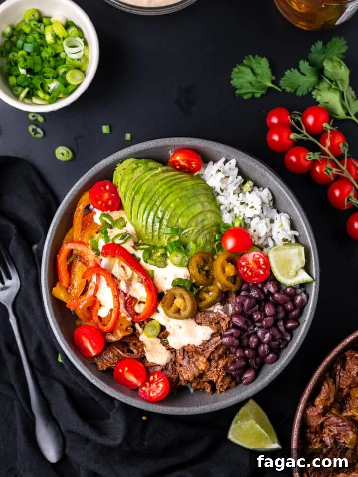 beef burrito bowl with avocado, black beans, queso sauce, sautéed veggies and rice