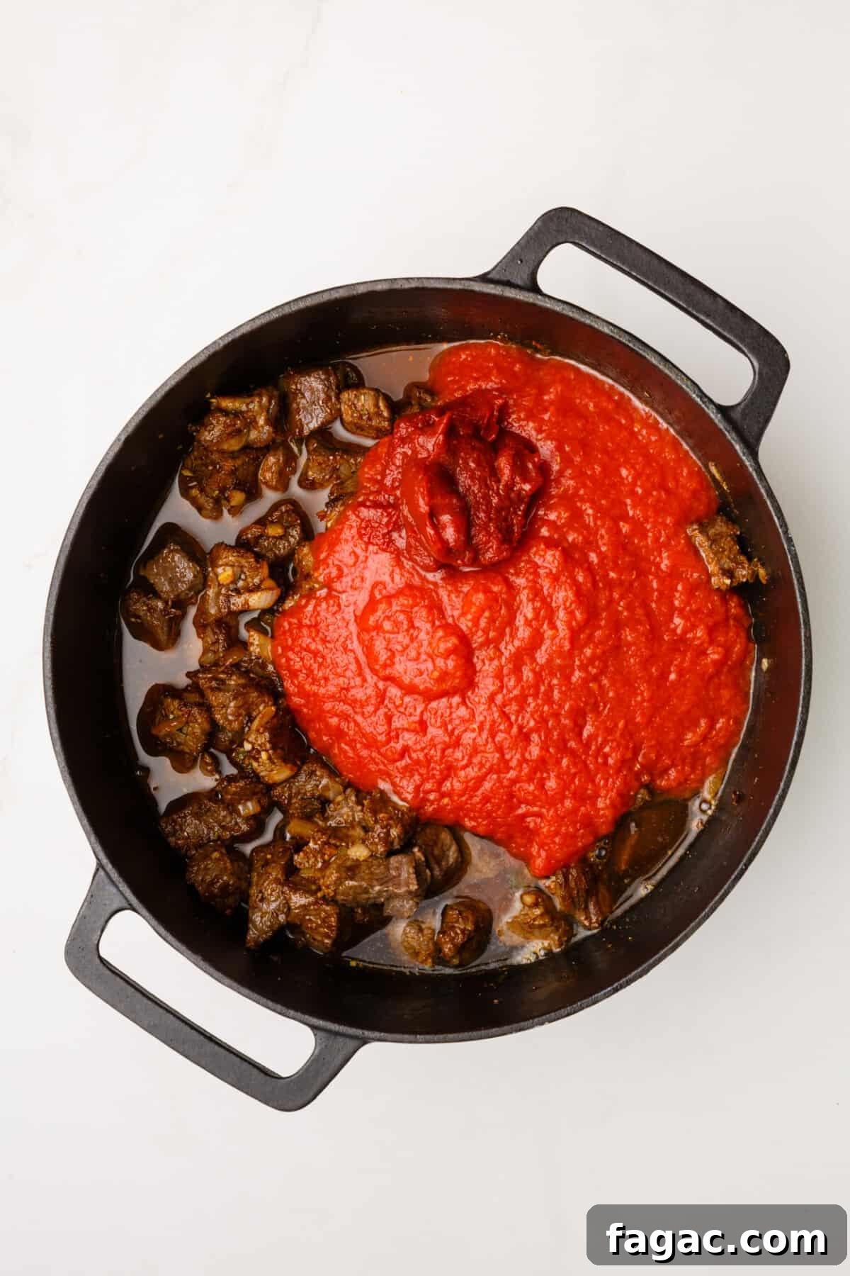 Authentic Texas Chili Recipe: Classic Beef and Spice Guide 11 dutch oven with cooked beef cubes, sauteed onion, garlic and jalapenos with tomato paste and broth