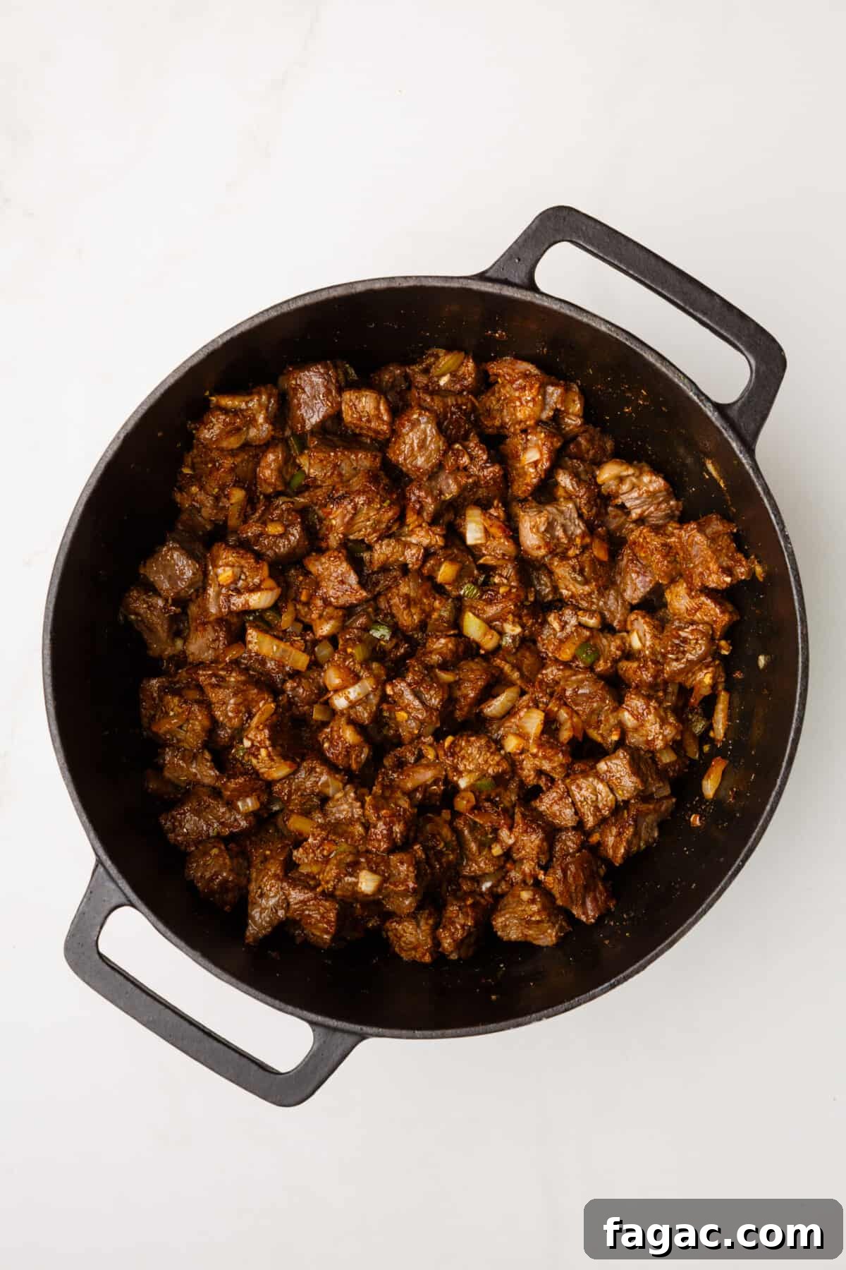 Authentic Texas Chili Recipe: Classic Beef and Spice Guide 10 dutch oven with cooked beef cubes, sauteed onion, garlic and jalapenos