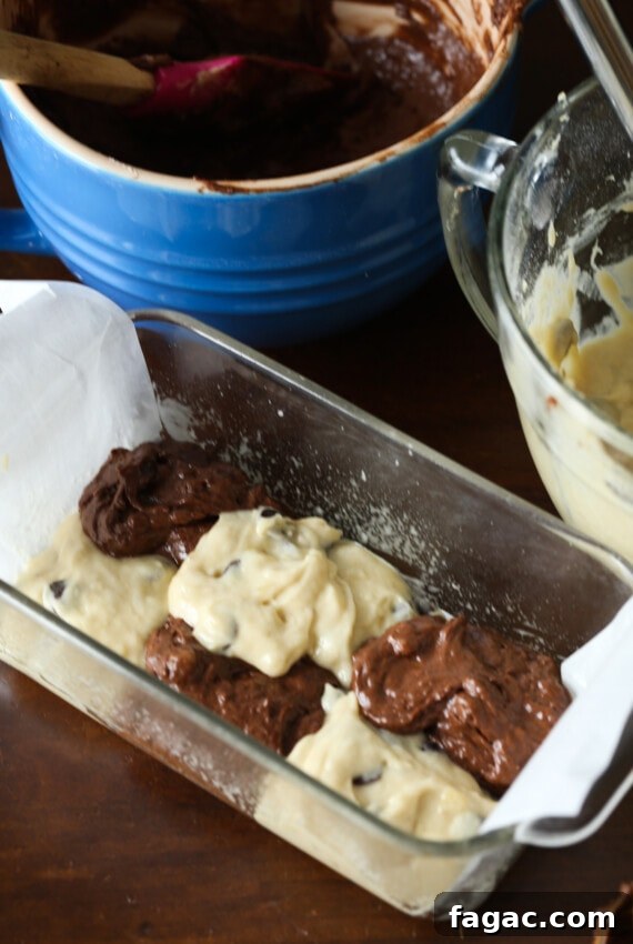 Chocolate Marble Banana Bread Recipe 6 Scoops of regular banana bread batter and chocolate banana bread batter are dropped into a loaf pan.