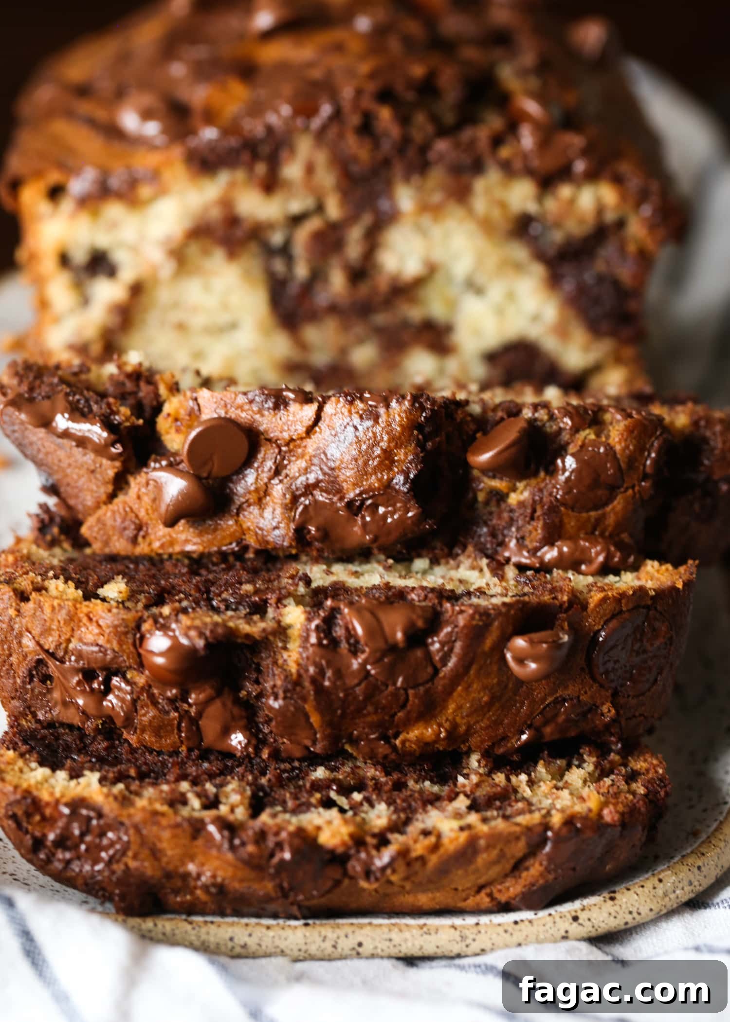 Chocolate Marble Banana Bread Recipe 10 A loaf of chocolate marbled banana bread sliced to reveal the marbled interior.