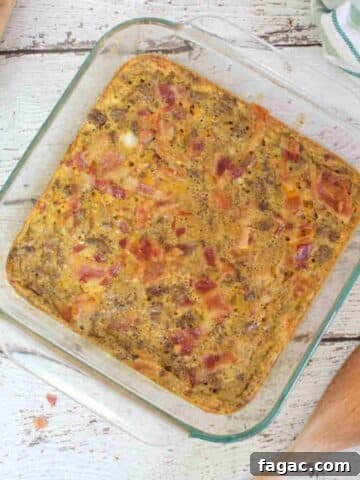 Carnivore casserole topped with bacon in a glass serving dish.