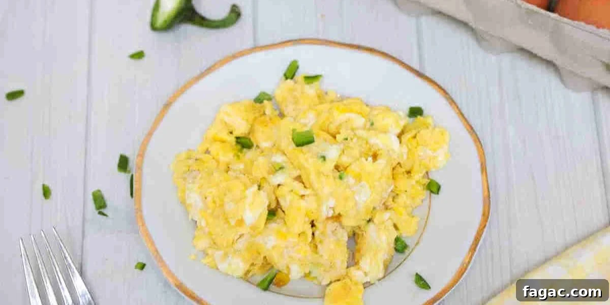 Dairy-free scrambled eggs on a white plate with jalapenos.