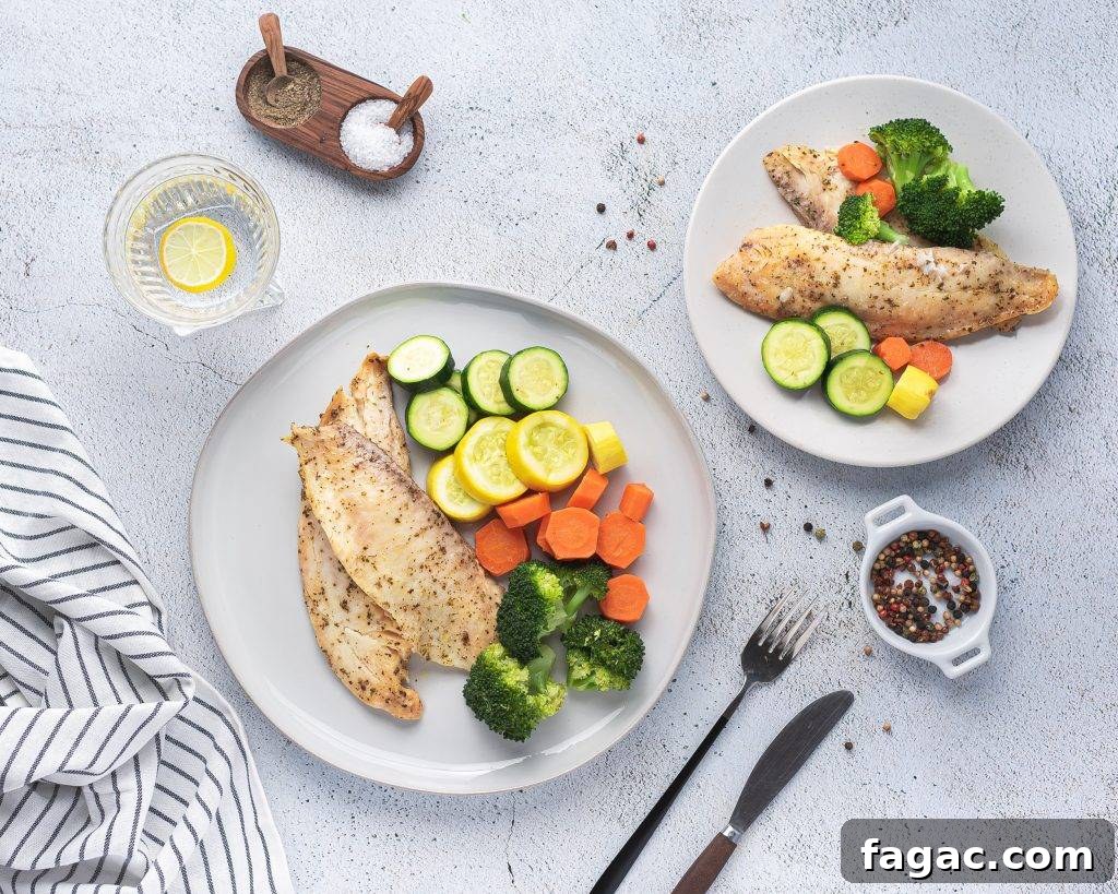 Instant pot tilapia with vegetables on white dinner plates with salt and pepper