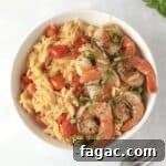 orzo with shrimp and tomatoes in a bowl