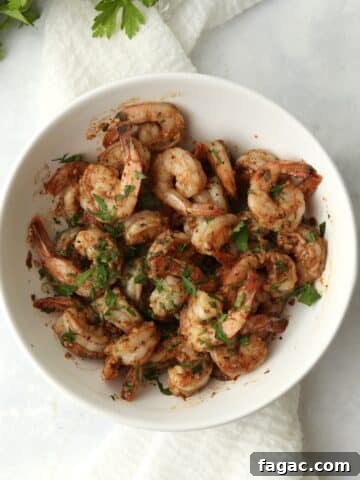 Blackstone cajun shrimp in a bowl with fresh parsley.