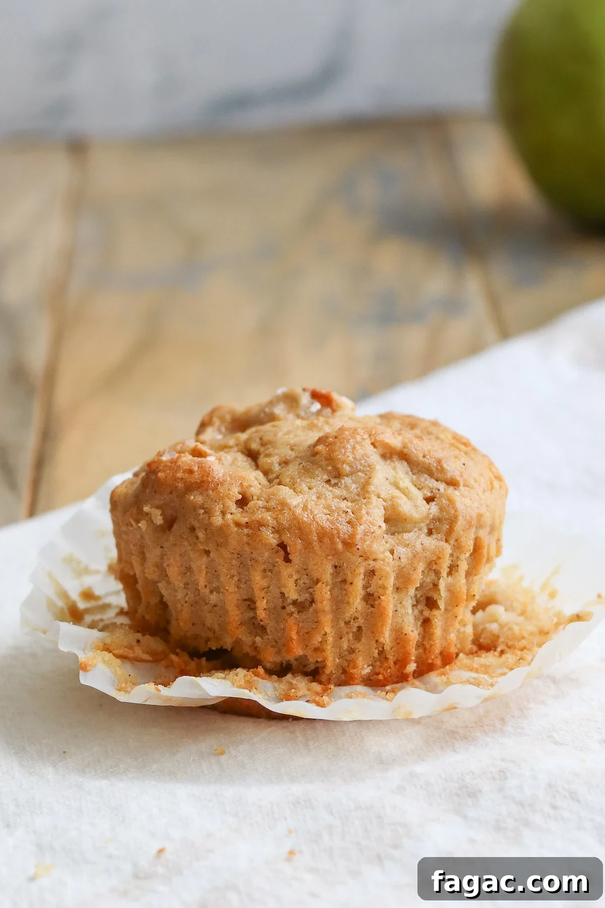 closeup of an unwrapped muffin with pears
