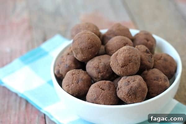Double Chocolate Peppermint Cookie Dough Bites: Guilt-Free Holiday Treat 3 Image shows a white bowl full of chocolate peppermint cookie dough balls sitting on a checkered napkin.