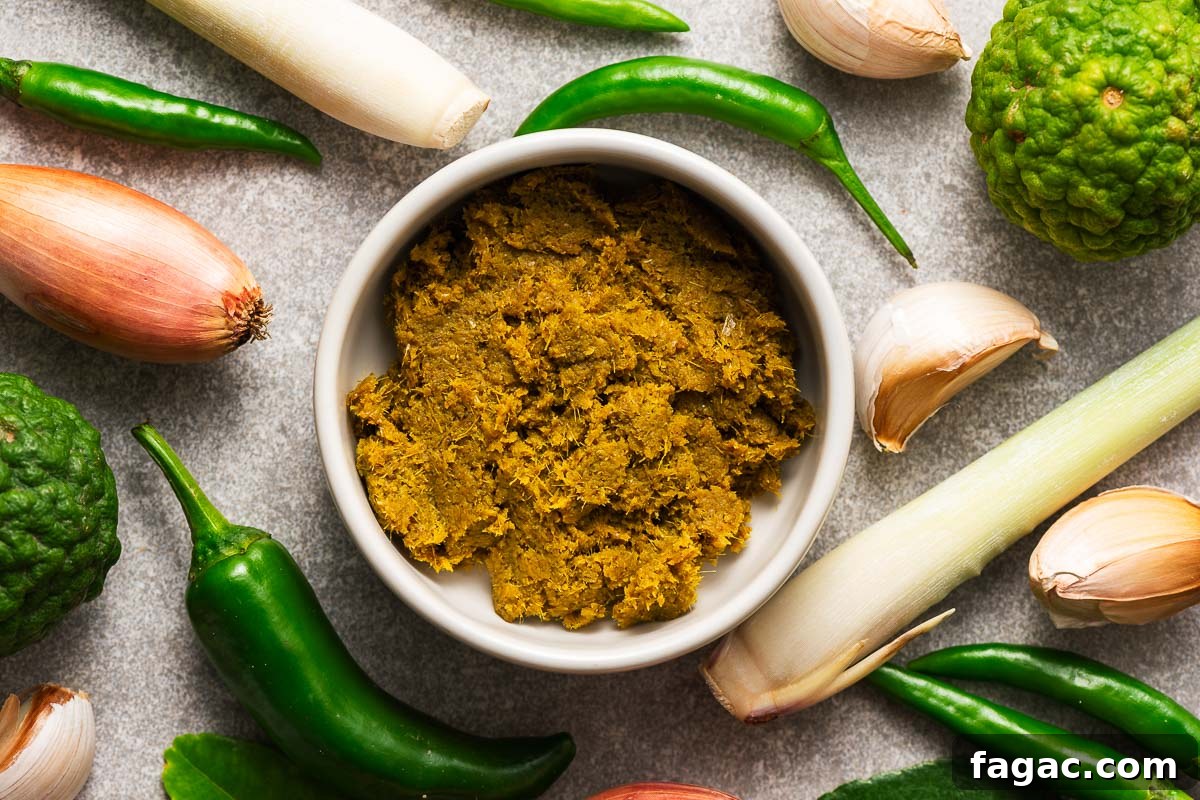 Thai Red Curry Paste Substitutes: What to Use and What to Avoid 4 A bowl with Thai green curry paste surrounded by key ingredients like green finger chillies, kaffir lime, lemongrass, garlic, and shallots.