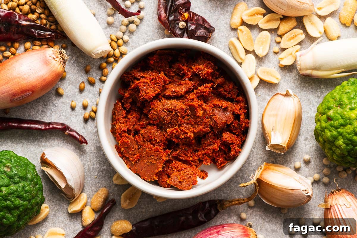 Thai Red Curry Paste Substitutes: What to Use and What to Avoid 7 A bowl with panang curry paste surrounded by key ingredients like dried red chillies, kaffir lime, lemongrass, garlic, shallot, coriander seeds, white pepper and peanuts.