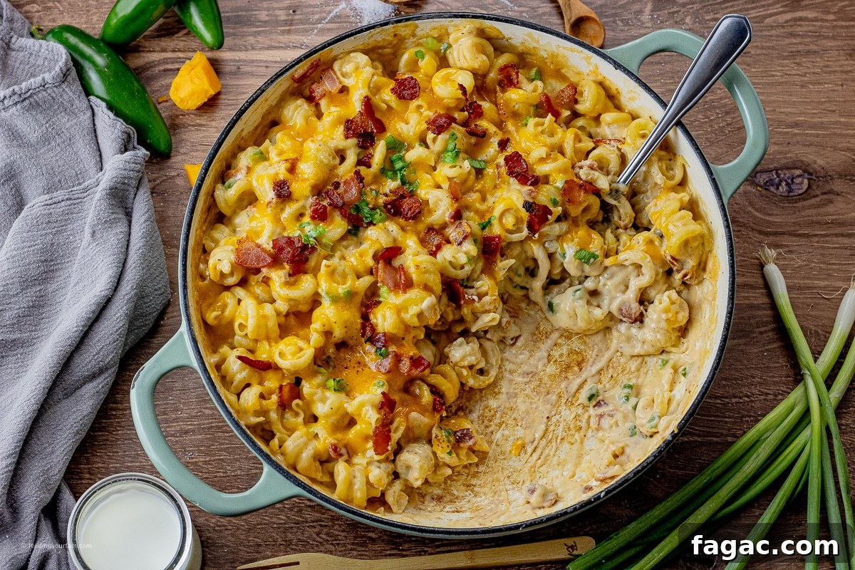 Jalapeño Popper Macaroni and Cheese Recipe 3 big pan of mac and cheese with bacon and jalapenos and some scooped out of the pan