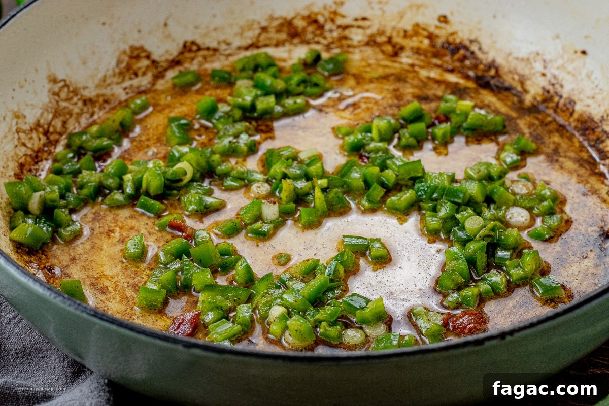 Jalapeño Popper Macaroni and Cheese Recipe 5 cooked jalapeno and green onions in a large pan in bacon grease