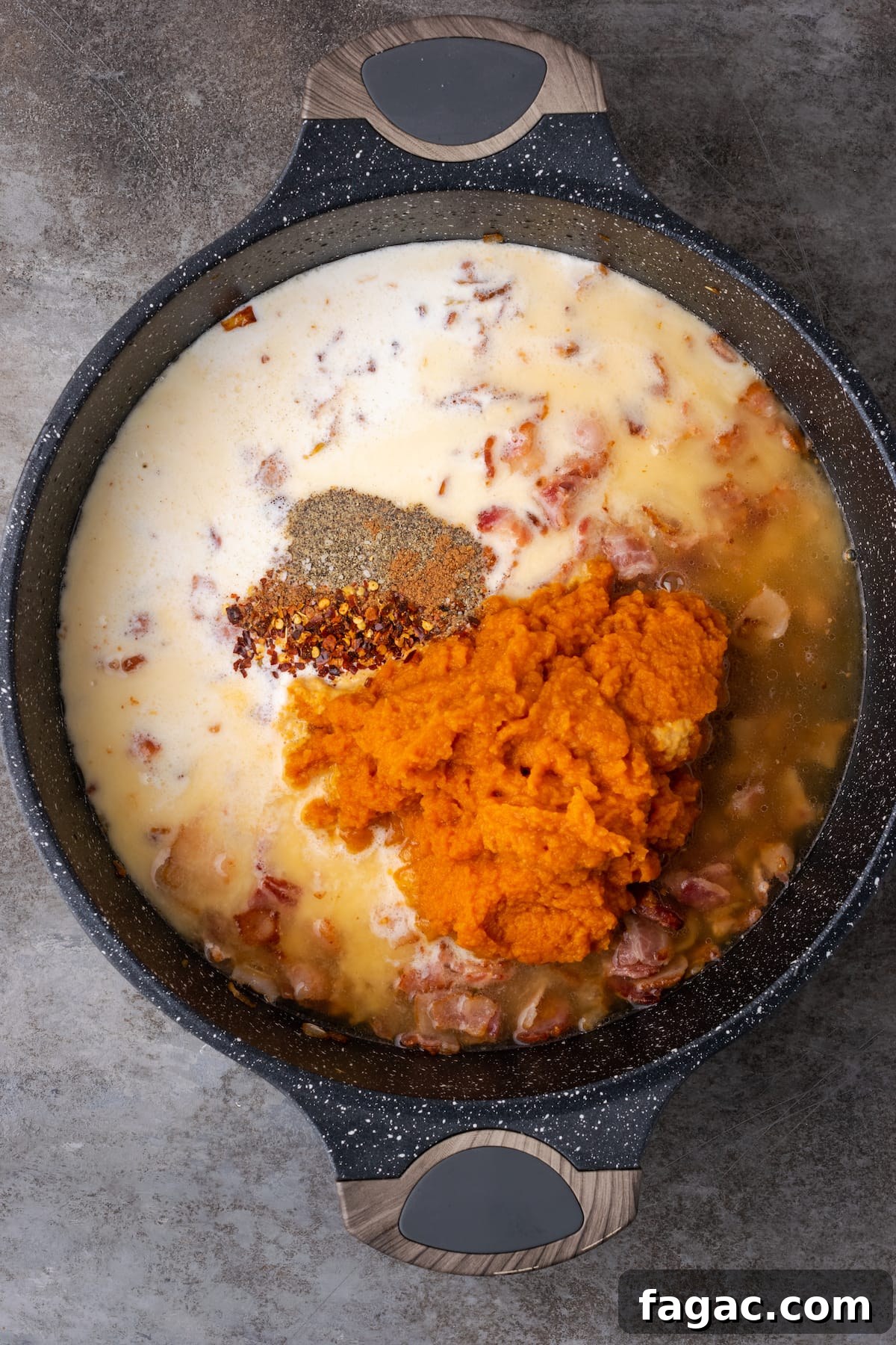 Pumpkin puree and the rest of the pumpkin sauce ingredients are added to a cast iron skillet with bacon and onion.