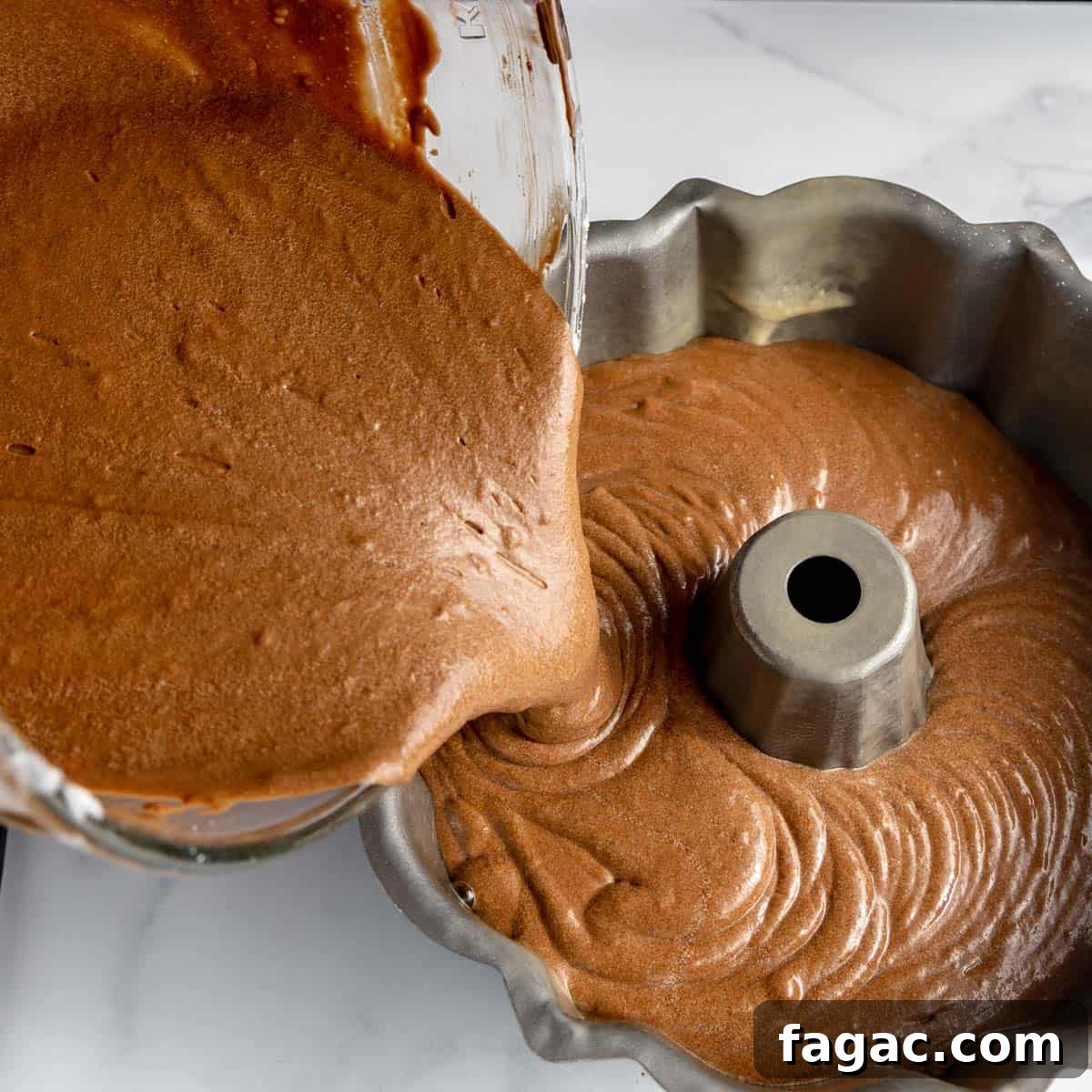 Chocolate cake batter poured into a bundt pan