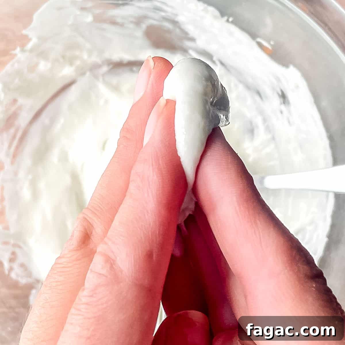 Two hands pressed together with melted marshmallows between