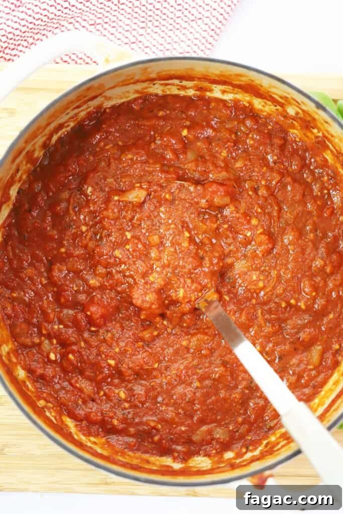 A Dutch oven full of the best marinara sauce.