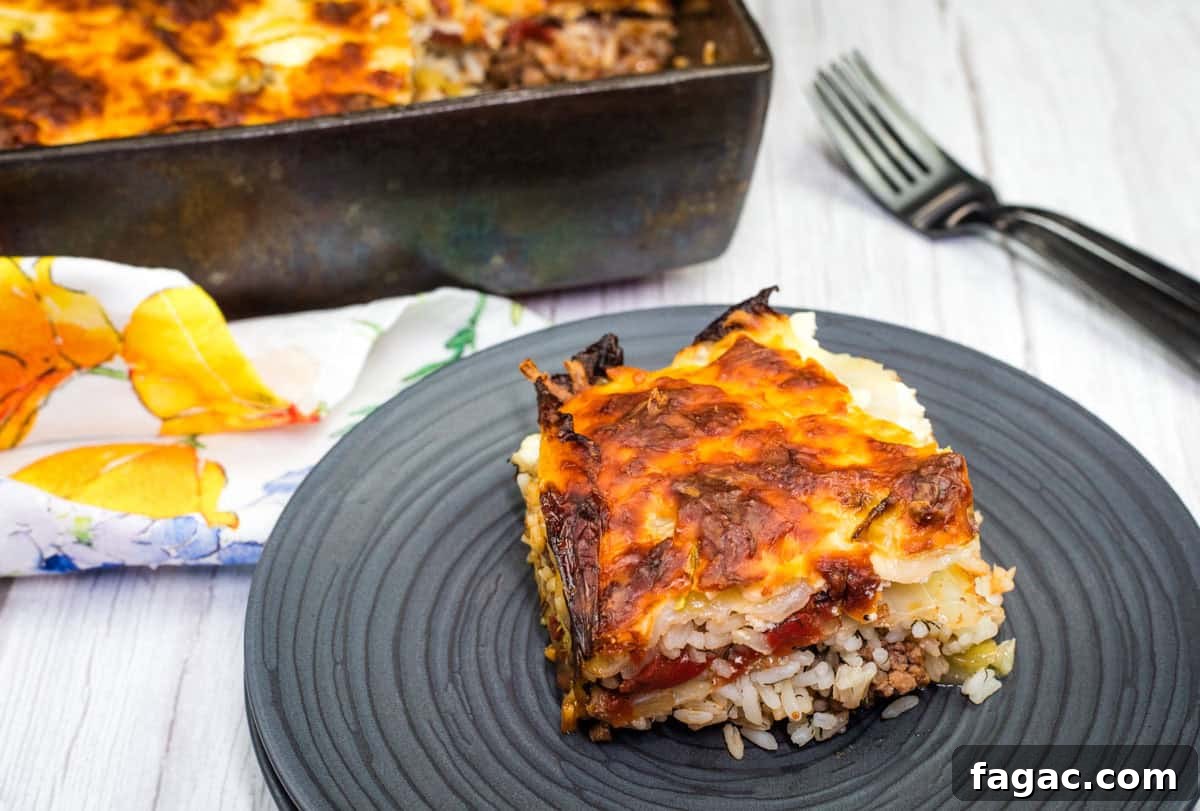 23 Classic Casseroles That Taste Like Grandma’s Comfort Cooking 19 A slice of Beefy cabbage roll casserole on a black plate.